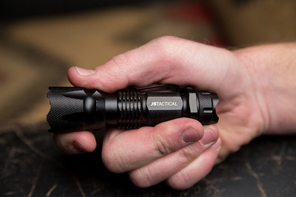 tactical flashlight in hand