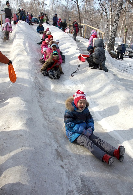 Children Going Down Snow Slide